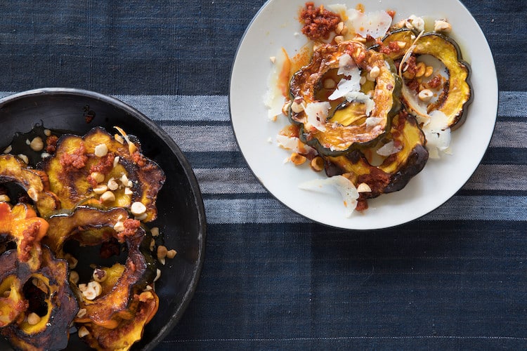 Calabaza Con Sobrasada is roasted Delicata squash with pork sausage, hazelnuts, Mahón cheese and honey. A sweet and savory side for Thanksgiving.