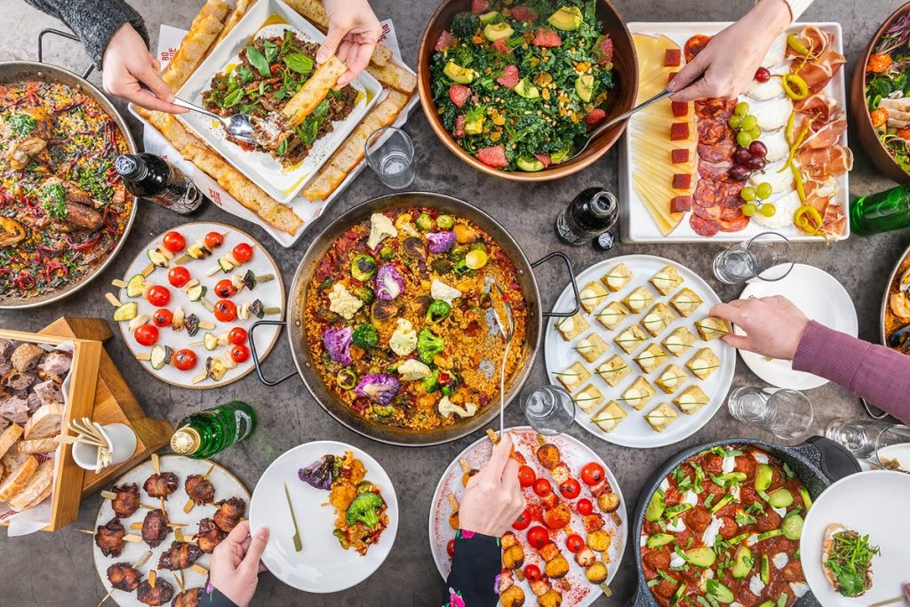 A long table of guests sharing tapas at a Boqueria private event
