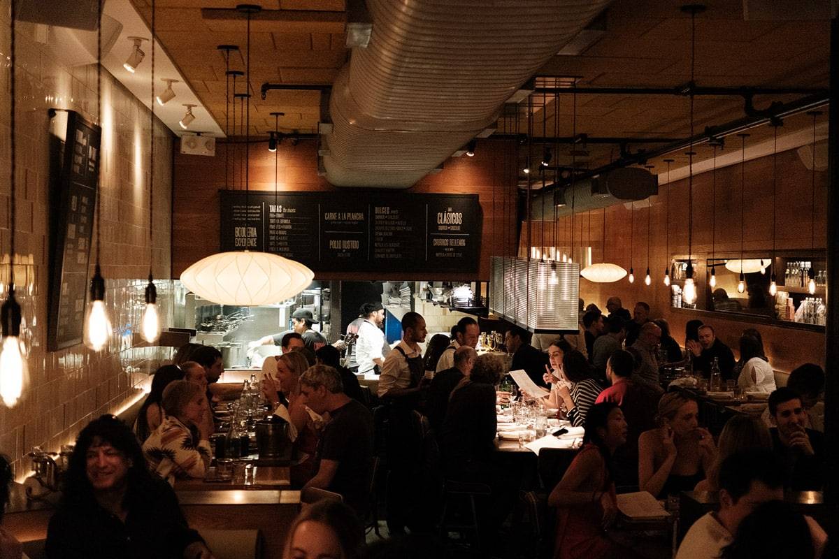 Inside Boqueria: the open kitchen and bar that anchor the Upper East Side room